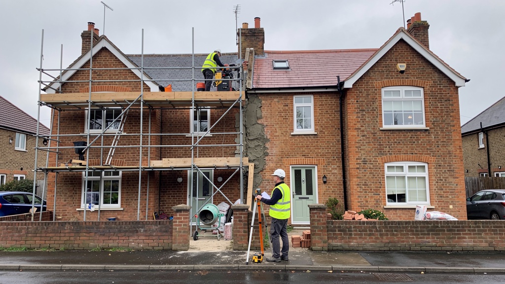 Party wall between two semi-detached houses with construction work in progress